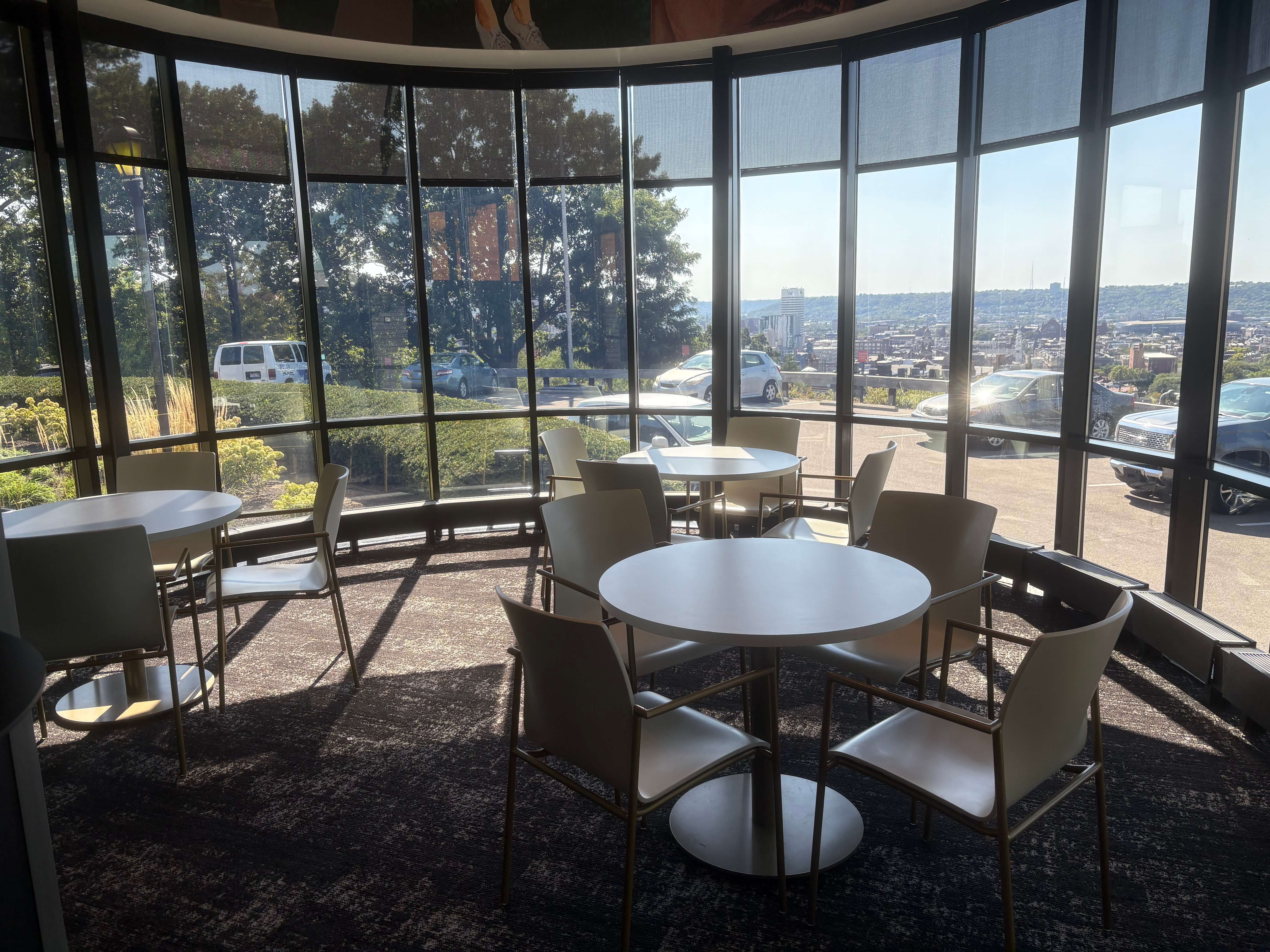 Three table in front of windows with an outlook on to downtown Cincinnati
