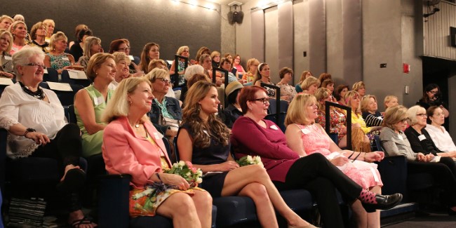 Leading ladies seated in a theatre