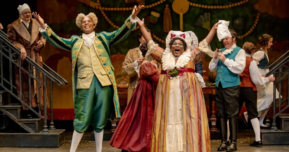 (Foreground) Kenneth Early (Mr. Fezziwig), Burgess Byrd (Mrs. Fezziwig), (background) Andrew May (Ebenezer Scrooge) and the cast of A Christmas Carol at Cincinnati Playhouse in the Park. Photo by Mikki Schaffner.