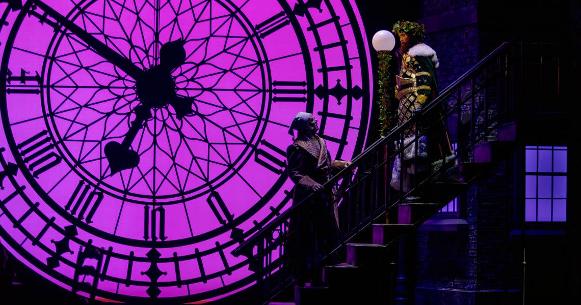 Andrew May (Ebenezer Scrooge) and Kenneth Early (Ghost of Christmas Present) in A CHRISTMAS CAROL at Cincinnati Playhouse in the Park. Photo by Mikki Schaffner.