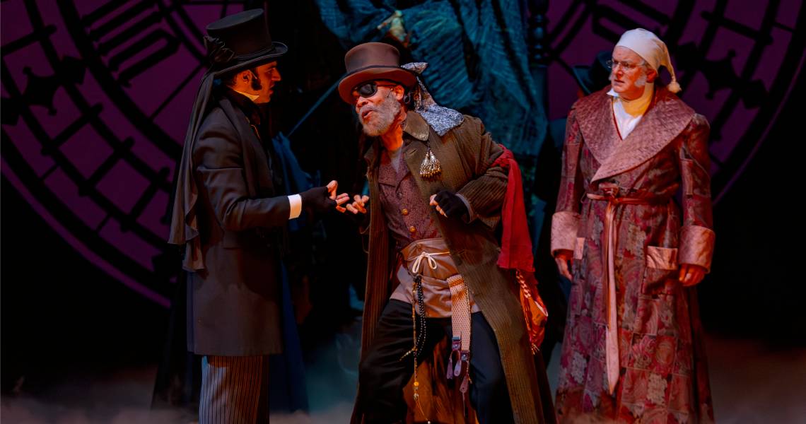 Alex Purcell (Undertaker), Jefferson A. Russell (Old Joe) and Andrew May (Ebenezer Scrooge) in A CHRISTMAS CAROL at Cincinnati Playhouse in the Park. Photo by Mikki Schaffner.